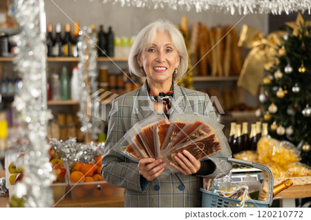 Elderly woman is looking and choose hamon in store. Elderly woman is looking and choose hamon in store. 120210772