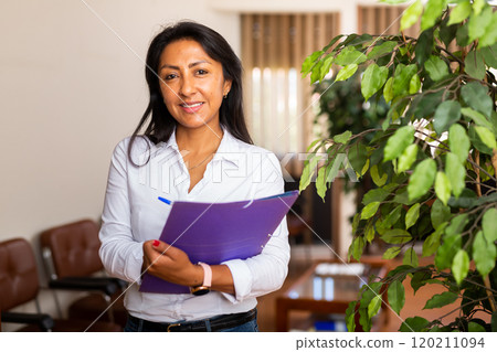 Portrait of business woman standing in office Portrait of business woman standing in office 120211094