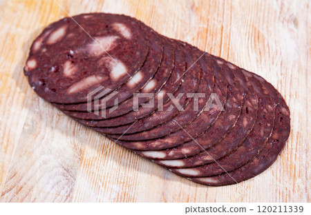 European cuisine blood pudding on white plate on wooden table 120211339