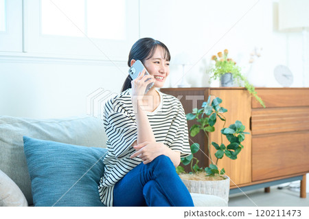 年輕女子在客廳打電話 120211473