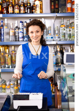 Woman works as salesperson in alcohol department of Russian store. 120211520