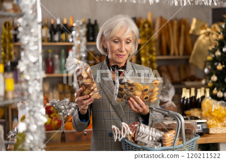 Elderly woman choosing cookies at grocery store 120211522