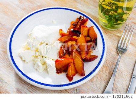 Cottage cheese with sour cream and sliced peach. 120211662