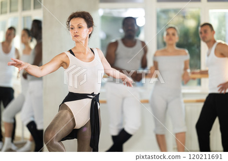 Adult woman teacher showing ballet movements 120211691