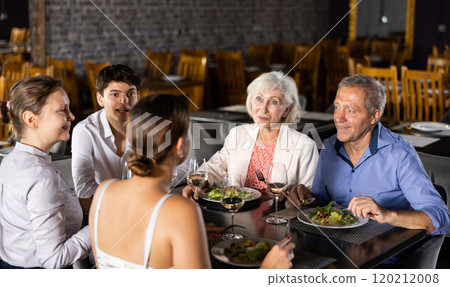 Large family, company of spouses in restaurant, eat, celebrate important event, communicate. 120212008
