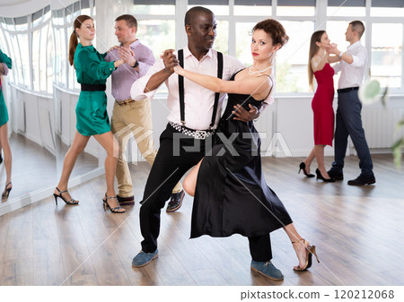 Middle-aged man and woman practicing waltz in dancing studio 120212068