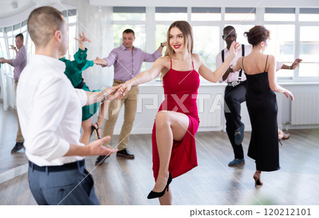 Woman dances incendiary boogie woogie with man partner during choreography lesson Woman dances incendiary boogie woogie with man partner during choreography lesson 120212101