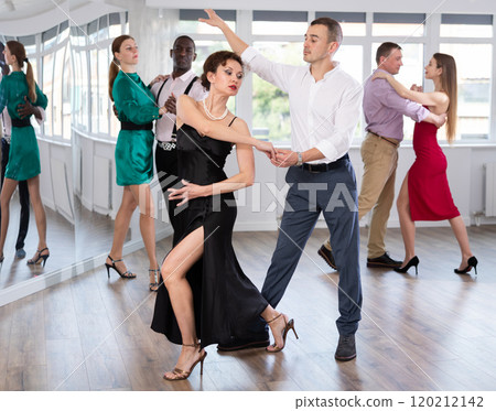 Man and woman dancing waltz in couple during lesson at studio Man and woman dancing waltz in couple during lesson at studio 120212142