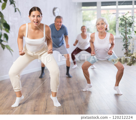 Portrait of active mature women enjoying modern energetic dancing in group in the studio Portrait of active mature women enjoying modern energetic dancing in group in the studio 120212224