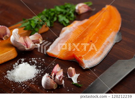 Raw trout fillet with greens and spices 120212239