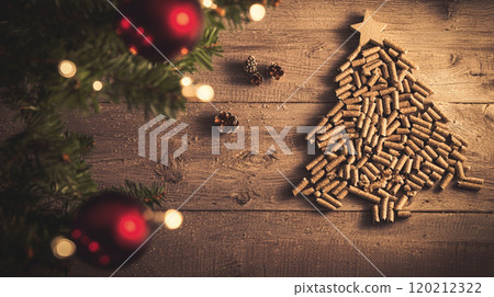 A top-down view of wood pellets meticulously arranged in the shape of a Christmas tree on a rustic wooden background. Generative AI 120212322