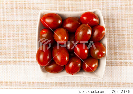 Close up of red ripe cherry tomato on table Close up of red ripe cherry tomato on table 120212326