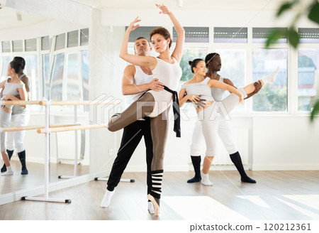 Man and girl woman together arabesque position of ballet during choreography studio Man and girl woman together arabesque position of ballet during choreography studio 120212361