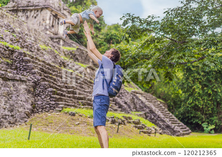 Father with his toddler son exploring the ancient pyramids of Palenque, Mexico, surrounded by dense jungle. Cultural heritage and adventure travel concept 120212365