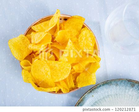 High angle view of fresh crunchy potato chips on table closeup 120212871