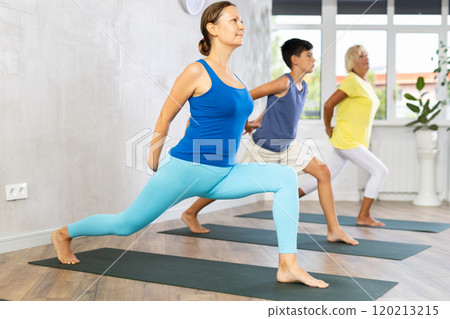 Group of three people doing yoga 120213215