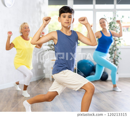 Happy preteen boy practicing dance positions during workout session Happy preteen boy practicing dance positions during workout session 120213315