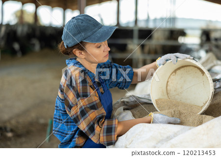 Adult woman scooping sand from bag Adult woman scooping sand from bag 120213453