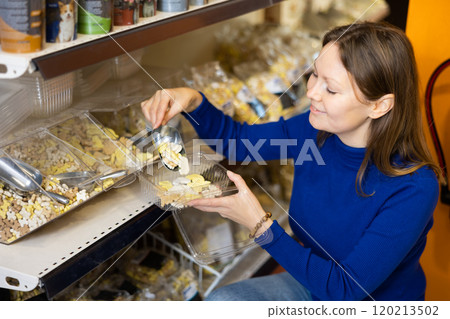 Young woman buying dry dog food at pet store 120213502