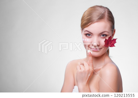 Skin care. Face of young woman girl with red maple leaf. 120213555