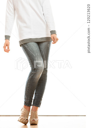 woman legs in denim trousers high heels shoes 120213620