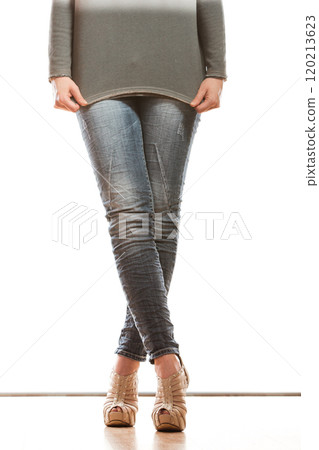 woman legs in denim trousers high heels shoes 120213623