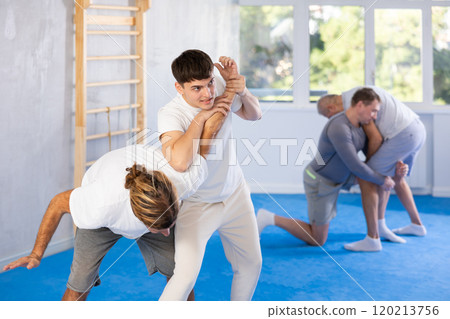 Two men training judo technique in studio 120213756