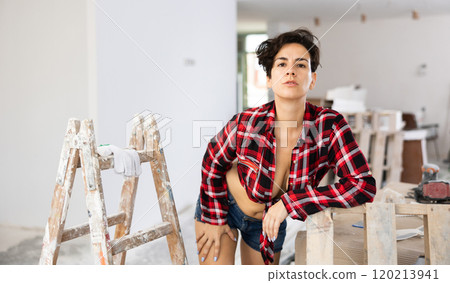 Playful topless girl in plaid shirt and shorts posing in cottage under construction 120213941