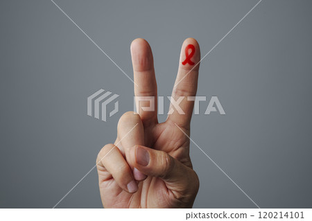 man doing V sign and red awareness ribbon 120214101