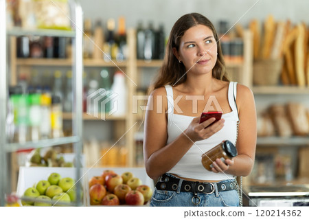 Young woman scanning qr code of lentils Young woman scanning qr code of lentils 120214362