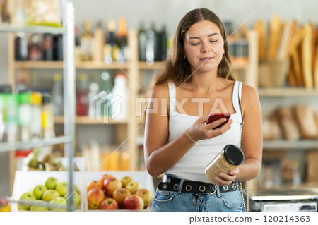 Young woman scanning qr code of beans Young woman scanning qr code of beans 120214363