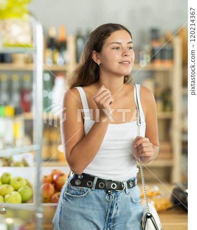Young woman choosing groceries in store 120214367