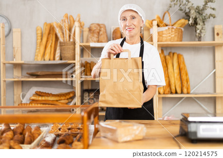 Elderly woman seller with bag of baked goods 120214575