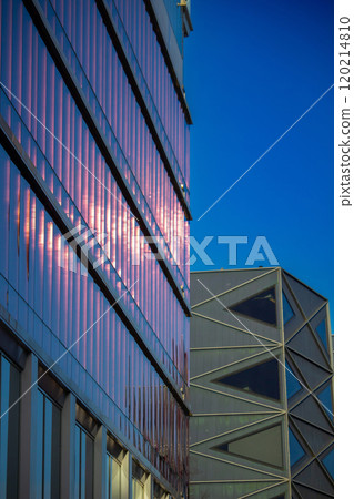Contemporary residential building exterior in the daylight. Modern apartment buildings on a sunny day with a blue sky. Contemporary residential building exterior in the daylight. Modern apartment buildings on a sunny day with a blue sky. 120214810