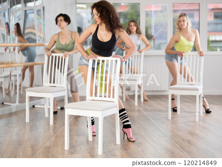 Brunette in heels leading group exotic chair dance class Brunette in heels leading group exotic chair dance class 120214849