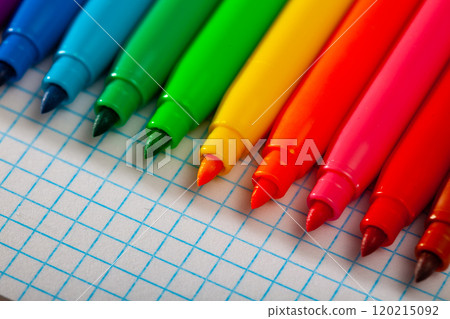 Set of multicolored felt tip on checkered sheet of paper Set of multicolored felt tip on checkered sheet of paper 120215092