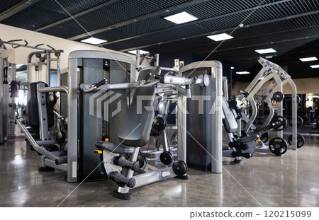 Interior of modern gym with weight training machines 120215099