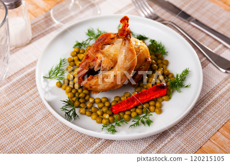 Roasted whole quail with peas on plate Roasted whole quail with peas on plate 120215105