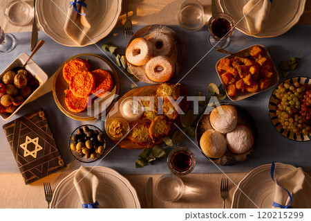 Top down shot of served table with traditional Jewish treats and Torah with star of David on cover Top down shot of served table with traditional Jewish treats and Torah with star of David on cover 120215299