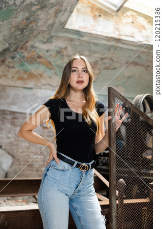 Tempting young woman posing in derelict building Tempting young woman posing in derelict building 120215386