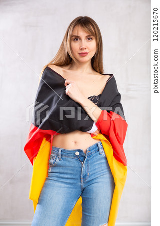 Young woman wrapped in Germany flag Young woman wrapped in Germany flag 120215670
