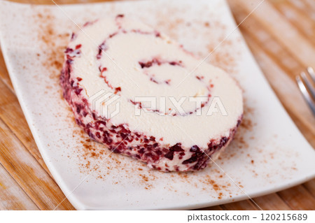 Slice of tasty cheese roll filled with cranberries closeup Slice of tasty cheese roll filled with cranberries closeup 120215689