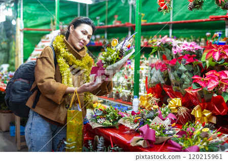 Asian female purchasing christmas bouquet at fair 120215961