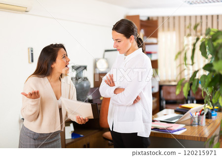 Unhappy woman chief screaming to young female manager 120215971