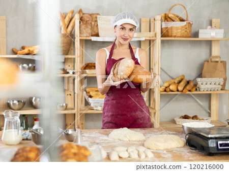 Young female baker with homemade bread 120216000