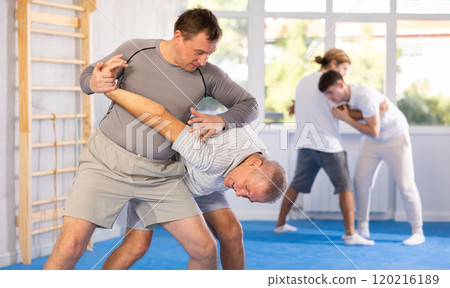 Adult and elderly men training judo fight Adult and elderly men training judo fight 120216189