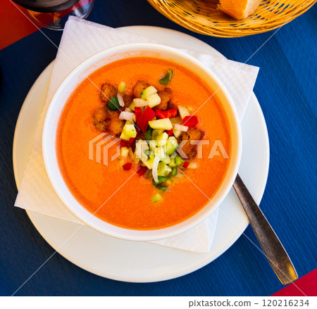 Andalusian cold soup gazpacho in bowl with cucumber and tomatoes 120216234