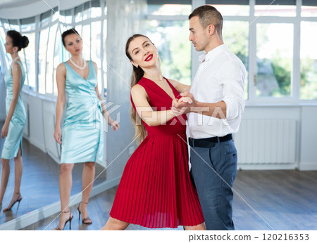 Elegant couple rehearsing sensual wedding dance in studio 120216353