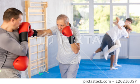 Two men training boxing fight in studio 120216357