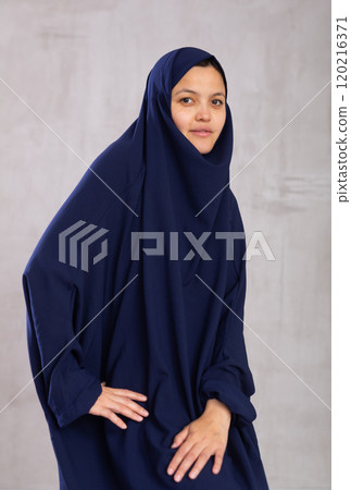 Portrait of young smiling woman in hijab posing in studio Portrait of young smiling woman in hijab posing in studio 120216371